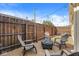 Gravel backyard featuring a round firepit surrounded by outdoor seating and string lights at 1019 Central Ave, Indianapolis, IN 46202