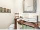 Modern powder room featuring a unique wood vanity, vessel sink, stylish mirror, and decorative accents at 1019 Central Ave, Indianapolis, IN 46202