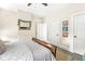 Well-lit bedroom with a wooden bed frame, wall art, and plush bedding at 1019 Central Ave, Indianapolis, IN 46202