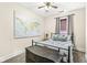 Cozy bedroom with a black metal bed frame, antique dresser, and a world map wall decoration at 1019 Central Ave, Indianapolis, IN 46202