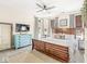 Bright bedroom with hardwood furniture, a large mirror, neutral decor, and multiple windows at 1019 Central Ave, Indianapolis, IN 46202