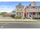 Charming two-story home with yellow siding and a welcoming front porch with bushes at 1019 Central Ave, Indianapolis, IN 46202