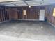 Spacious garage with bare walls, open ceiling, and gray concrete flooring at 1019 Central Ave, Indianapolis, IN 46202