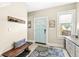 Inviting hallway with a wooden bench, a blue accent door, and built-in storage at 1019 Central Ave, Indianapolis, IN 46202