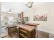 Open-concept space with kitchen island, seating, living area, and exposed brick fireplace at 1019 Central Ave, Indianapolis, IN 46202