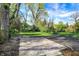 View of the paved parking area, green lawn, and mature trees at 22 W 54Th St, Indianapolis, IN 46208