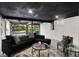 Stylish basement living area featuring modern seating, glass coffee table, and garage door access at 22 W 54Th St, Indianapolis, IN 46208