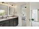Bright bathroom featuring a double sink vanity and an open doorway to the Primary bedroom at 22 W 54Th St, Indianapolis, IN 46208