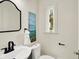 Bathroom featuring sleek black fixtures, a modern sink, and a bright window at 22 W 54Th St, Indianapolis, IN 46208