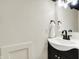 Modern bathroom vanity featuring black fixtures, stylish mirror, and fresh white towel at 22 W 54Th St, Indianapolis, IN 46208