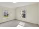 Bright bedroom featuring neutral carpet, white walls, and natural light from the two windows at 22 W 54Th St, Indianapolis, IN 46208