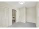 Empty bedroom with neutral walls and carpet, features an open door to a hallway at 22 W 54Th St, Indianapolis, IN 46208