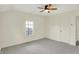 Neutral bedroom featuring a ceiling fan, a window, and an entry door at 22 W 54Th St, Indianapolis, IN 46208