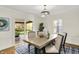 Dining area with a modern table, chairs, a sliding door, and updated light fixture at 22 W 54Th St, Indianapolis, IN 46208