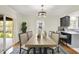 Dining room featuring a contemporary chandelier, stylish chairs, and hardwood floors at 22 W 54Th St, Indianapolis, IN 46208
