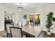 Dining room showcasing modern light fixture, a wooden table, and access to the screened porch at 22 W 54Th St, Indianapolis, IN 46208