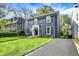 Charming two-story home with a brick facade, black shutters, manicured lawn, and inviting walkway at 22 W 54Th St, Indianapolis, IN 46208