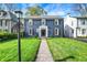 Charming two-story home with a brick facade, black shutters, manicured lawn, and inviting walkway at 22 W 54Th St, Indianapolis, IN 46208