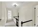 Upstairs hallway boasting carpet flooring, white walls, and a black and white banister, creating a bright transition at 22 W 54Th St, Indianapolis, IN 46208