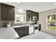 Modern kitchen with gray cabinets, stainless appliances, and white marble-look countertops at 22 W 54Th St, Indianapolis, IN 46208