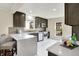 Bright kitchen with dark cabinets, white countertops, stainless steel appliances, and a breakfast bar area, ideal for casual dining at 22 W 54Th St, Indianapolis, IN 46208