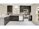 Modern kitchen features dark cabinets, a white countertop, and stainless steel appliances, creating a stylish cooking space at 22 W 54Th St, Indianapolis, IN 46208