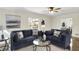 Comfortable living room with stylish sofas, hardwood floors, a glass coffee table, and natural light at 22 W 54Th St, Indianapolis, IN 46208