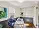 Bright home office boasts custom shelves, wainscoting, and a comfortable blue chair at 22 W 54Th St, Indianapolis, IN 46208
