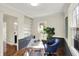 Home office featuring custom built-in shelves, rich wood floors, and a blue leather chair at 22 W 54Th St, Indianapolis, IN 46208