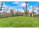 Grassy backyard with shed, blue sky, and bare trees at 120 Hugo St, Indianapolis, IN 46229