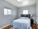 Cozy bedroom featuring a bed, two windows, and a nightstand at 120 Hugo St, Indianapolis, IN 46229