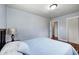 Neutral bedroom featuring light blue walls, wood floors, and closet storage at 120 Hugo St, Indianapolis, IN 46229