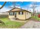 Charming single-story home featuring shuttered windows and a covered entryway and a blue sky at 120 Hugo St, Indianapolis, IN 46229