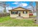 Charming single-story home featuring a yellow exterior, brown shutters, and a well-maintained front yard at 120 Hugo St, Indianapolis, IN 46229
