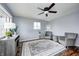 Bright living room featuring hardwood floors, grey walls, a ceiling fan, and plenty of natural light at 120 Hugo St, Indianapolis, IN 46229