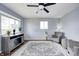 Inviting living room featuring hardwood floors, grey walls, a ceiling fan, and plenty of natural light at 120 Hugo St, Indianapolis, IN 46229
