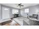 Comfortable living room featuring a ceiling fan, hardwood floors, and a view of the front yard at 120 Hugo St, Indianapolis, IN 46229