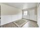 Neutral room featuring a door, window, white trim, and plank flooring at 120 Hugo St, Indianapolis, IN 46229