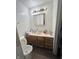 Small bathroom with wood vanity and linoleum floor at 6602 Lennington Dr, Indianapolis, IN 46226