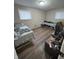Simple bedroom with wood-look flooring and two beds at 6602 Lennington Dr, Indianapolis, IN 46226
