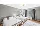 Spacious bedroom with two twin beds, hardwood floors, and large window at 6996 N Washington Blvd, Indianapolis, IN 46220