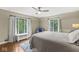 Bedroom with a queen bed, hardwood floors, and large windows at 6996 N Washington Blvd, Indianapolis, IN 46220