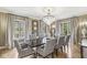 Elegant dining room with hardwood floors, chandelier, and large windows at 6996 N Washington Blvd, Indianapolis, IN 46220
