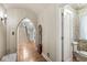 Elegant entryway with hardwood floors, arched doorways, and powder room at 6996 N Washington Blvd, Indianapolis, IN 46220