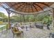 Landscaped backyard with a gazebo and patio furniture at 6996 N Washington Blvd, Indianapolis, IN 46220