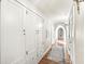 Bright hallway with hardwood floors, built-in storage, and arched entryways at 6996 N Washington Blvd, Indianapolis, IN 46220