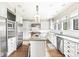 Modern kitchen with white cabinets, granite counters, and stainless steel appliances at 6996 N Washington Blvd, Indianapolis, IN 46220