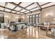 Living room with hardwood floors, beamed ceiling, and ample seating at 6996 N Washington Blvd, Indianapolis, IN 46220