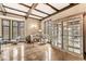 Living room with hardwood floors, built-in shelving, and large windows at 6996 N Washington Blvd, Indianapolis, IN 46220