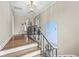 Elegant staircase with wrought-iron railing and hardwood steps at 6996 N Washington Blvd, Indianapolis, IN 46220